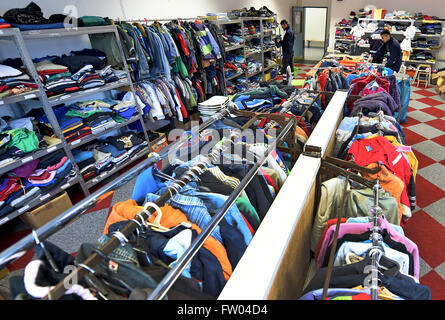 Bad Fallingbostel, Germany. 30th Mar, 2016. Workers and volunterrs with the Johanniter Accident Help sort clothes at the Camp Bad Fallingbostel West refugee accommodation in Bad Fallingbostel, Germany, 30 March 2016. Around 200 are currently being housed in Camp West. Photo: HOLGER HOLLEMANN/dpa/Alamy Live News Stock Photo