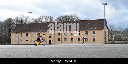 Bad Fallingbostel, Germany. 30th Mar, 2016. A refugee child rides a bicycle at the site of the Camp Bad Fallingbostel Ost refugee accommodation in Bad Fallingbostel, Germany, 30 March 2016. Around 850 are currently being housed in Camp Ost. Photo: HOLGER HOLLEMANN/dpa/Alamy Live News Stock Photo