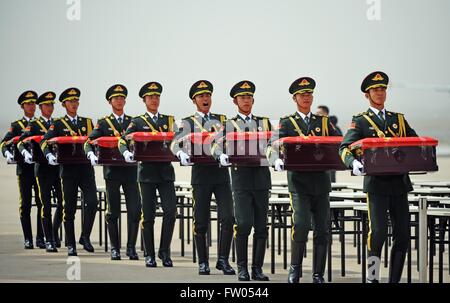 Shenyang, China. 31st March, 2016. Soldiers of the Chinese People's Liberation Army carry coffins containing remains of soldiers of the Chinese People's Volunteers (CPV) killed in the 1950-53 Korean War, at the Taoxian International Airport in Shenyang, northeast China's Liaoning Province, March 31, 2016. The remains of 36 Chinese soldiers killed in the 1950-53 Korean War were returned to China on Thursday from the Republic of Korea (ROK), the third batch returned following a handover agreement signed by the two countries in 2013. Credit:  Xinhua/Alamy Live News Stock Photo