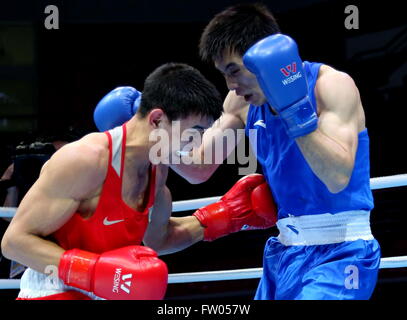 Qian'an, China's Hebei Province. 31st Mar, 2016. Zhussupov Ablaikhan (L) of Kazakhstan competes against Hu Qianxun of China during their semifinal of men's 64kg category of Asia/Oceania Zone boxing event qualifier for 2016 Rio Olympic Games in Qian'an, north China's Hebei Province, March 31, 2016. Zhussupov Ablaikhan won 3-0. © Yang Shiyao/Xinhua/Alamy Live News Stock Photo