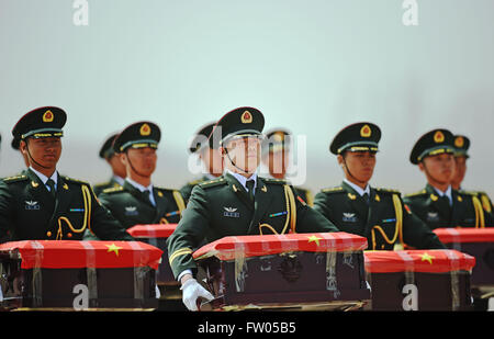 Shenyang, China. 31st March, 2016. Soldiers of the Chinese People's Liberation Army carry coffins containing remains of soldiers of the Chinese People's Volunteers (CPV) killed in the Korean War, at the Taoxian International Airport in Shenyang, northeast China's Liaoning Province, March 31, 2016. The remains of 36 Chinese soldiers killed in the 1950-53 Korean War were returned to China on Thursday from the Republic of Korea (ROK), the third batch returned following a handover agreement signed by the two countries in 2013. Credit:  Xinhua/Alamy Live News Stock Photo