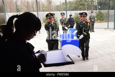 Shenyang, China. 31st March, 2016. Soldiers of the Chinese People's Liberation Army escort coffins containing remains of soldiers of the Chinese People's Volunteers (CPV) killed in the Korean War, at a martyr cemetery in Shenyang, northeast China's Liaoning Province, March 31, 2016. The remains of 36 Chinese soldiers killed in the 1950-53 Korean War were returned to China on Thursday from the Republic of Korea (ROK), the third batch returned following a handover agreement signed by the two countries in 2013. Credit:  Xinhua/Alamy Live News Stock Photo