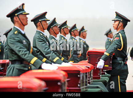 Shenyang, China. 31st March, 2016. Soldiers of the Chinese People's Liberation Army carry coffins containing remains of soldiers of the Chinese People's Volunteers (CPV) killed in the Korean War, at the Taoxian International Airport in Shenyang, northeast China's Liaoning Province, March 31, 2016. The remains of 36 Chinese soldiers killed in the 1950-53 Korean War were returned to China on Thursday from the Republic of Korea (ROK), the third batch returned following a handover agreement signed by the two countries in 2013. Credit:  Xinhua/Alamy Live News Stock Photo