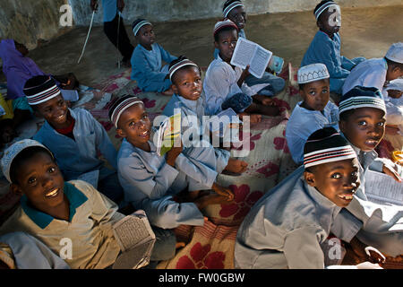 Young Boy in Madrassa (Koranic School). Kizimkazi Dimbani, Zanzibar, Tanzania. Practicing and reading the Koran Stock Photo