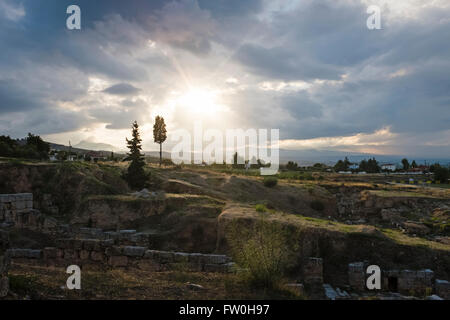 Roman theatre ruins, at dusk, in Corinth,  an ancient city-state (polis) on the Isthmus of Corinth, Peleponnese, Greece, the Mediterranean Stock Photo