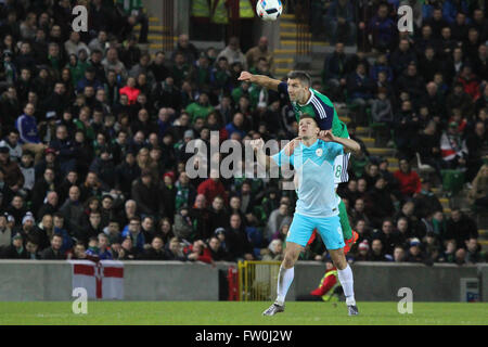 28 March 2016 - Vauxhall International Challenge (Friendly). Northern Ireland 1 Slovenia 0. Northern Ireland's Aaron Hughes wins this aerial battle with Roman Bzjak (9). Stock Photo