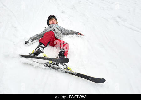 The boy on skis in mountains Stock Photo