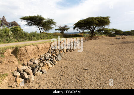 Lake Langano, Ethiopia, October 2013 Alutu Ridge – villagers have stacked stones in the riverbed to protect the road from erosion. Stock Photo