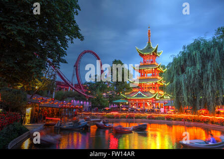 Dragon Boat lake and Dæmonen roller coaster in the background at Tivoli gardens, Copenhagen, Denmark Stock Photo