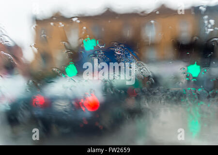 Blurred picture of traffic through a car windscreen during heavy rain. Stock Photo