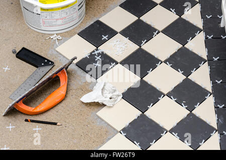 DIY laying a tile floor at home Stock Photo