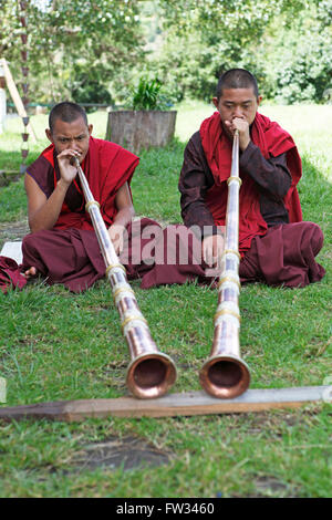 Monks playing tibetan horns, Chimi Temple, Punakha District, Bhutan Stock Photo