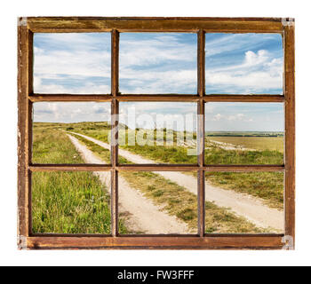 prairie road as seen  through vintage, grunge, sash window with dirty glass Stock Photo