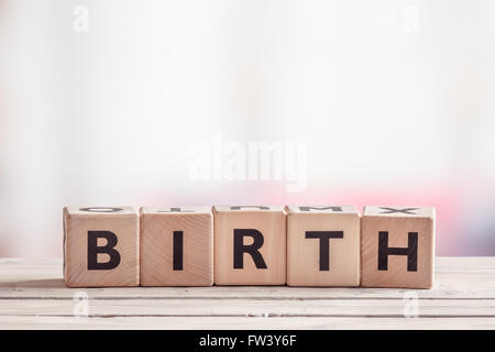 Birth sign made of wooden cubes on a table Stock Photo
