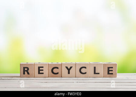 Recycle sign with blocks on a wooden table Stock Photo