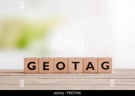 Geotag sign on an outdoor wooden table Stock Photo