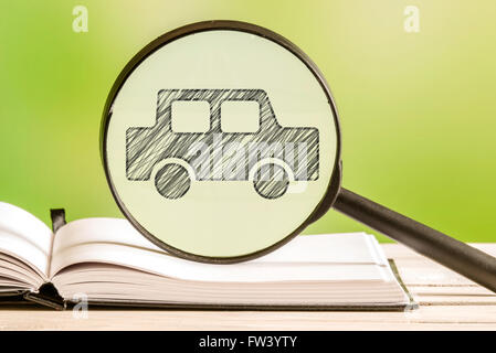 Car search with a pencil drawing of an automobile in a magnifying glass Stock Photo