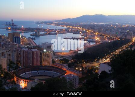 Elevated view of the bullring and port area at dusk, Malaga, Costa del Sol, Malaga Province, Andalusia, Spain, Western Europe. Stock Photo
