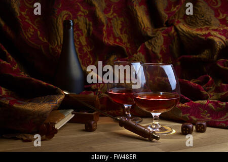 Two glasses of brandy on a wooden table Stock Photo