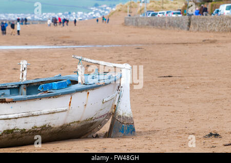 An old fishing boat moored on the beach at low tide Stock Photo