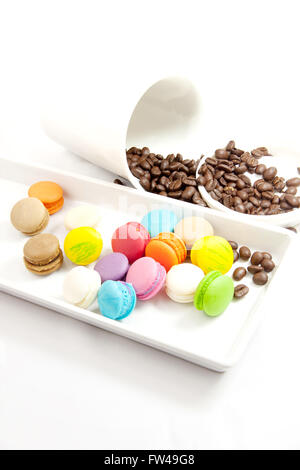 Colorful macaroon in white caramic plate on white background verticle. Stock Photo