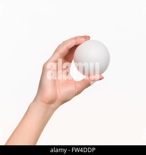 The female hand holding white blank styrofoam ball Stock Photo