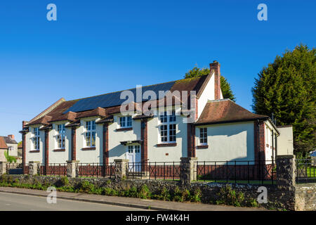 Photovoltaic solar panels on the roof of a village hall. Wrington, North Somerset, England. Stock Photo