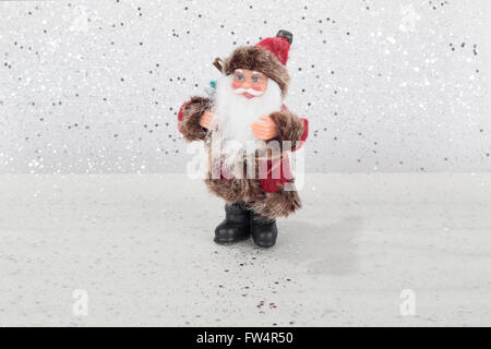 Santa Claus doll on silver and white background Stock Photo