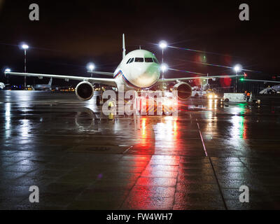 Pulkovo (LED) Airport, Saint Petersburg, Russia - January 28, 2016: Ground crew prepared the aircraft for take-off Stock Photo