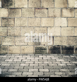 Empty abstract interior background with old stone wall and gray cobblestone pavement Stock Photo