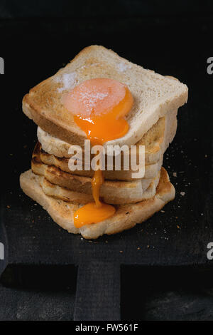 Toasts with yolk over black Stock Photo