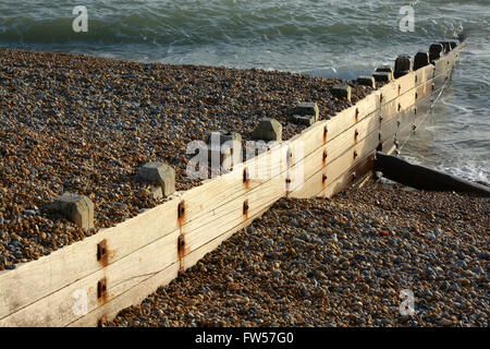 Wooden groyne beach defences on shingle beach at Brighton, East Sussex, England. Stock Photo