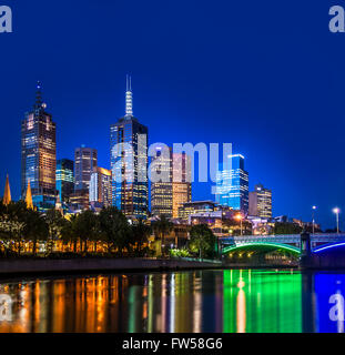 Illuminated city skyline at night of Melbourne CBD. A view from Yarra River on the southbank side of the city, looking up toward Princes Bridge