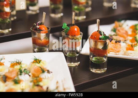 Catering for party. Close up of sandwiches, appetizers and fruit. Canapes Stock Photo