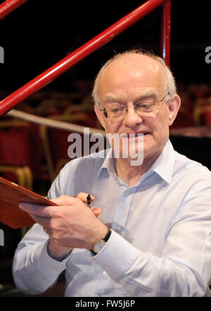 John Rutter, composer and editor, signing copies of the score before conducting his Requiem in the Royal Albert Hall with the Really Big Chorus, for Concerts from Scratch. Stock Photo