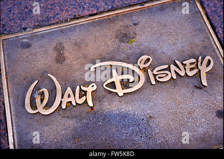 Walt disney bronze plaque set into the pavement of Leicester Square: of the name Walt Disney, founder of Hollywood Studio. Stock Photo