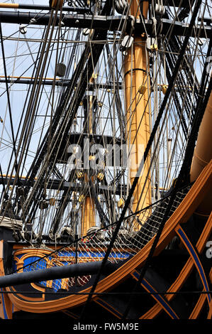 bows and rigging of HMS Victory, in Portsmouth Historic Dockyard. The only surviving naval warship that represents the skill of naval dockyard shipwrights, ship designers and the industrial ability of Britain during the mid 18th century. She was Admiral Lord Nelson's flagship at the battle of Trafalgar, 21 October 1805, the most decisive British naval victory of the Napoleonic Wars (1803-1815). Twenty-seven British ships defeated thirty-three French and Spanish ships under French Admiral Pierre Villeneuve. The British victory spectacularly confirmed the naval supremacy that Britain had establi Stock Photo