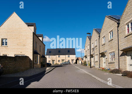 Solar panels on houses in a new housing development on the outskirts of Cirencester, Gloucestershire, UK Stock Photo