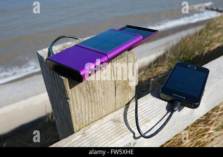 mobile phone solar powered battery charger Stock Photo