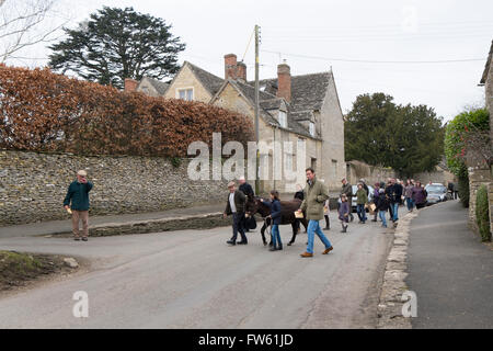 Procession of local people with a donkey to celebrate Palm Sunday in Southrop, Gloucestershire, UK Stock Photo