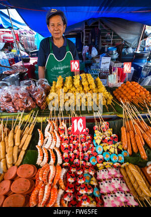 Market stall with various skewers with meat, fish and sausage, food stall, food for sale at a night market, Thailand Stock Photo