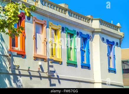 Colourful row of brightly painted window frames on Victorian era building, Fitzroy, Melbourne Australia Stock Photo