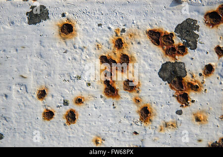 Weathered and rusty piece of cracked white painted metal Stock Photo