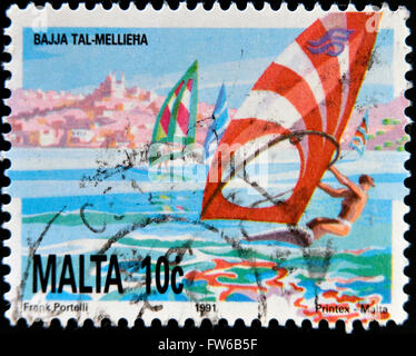 MALTA - CIRCA 1991: A stamp printed in Malta shows windsurfing in Mellieha Bay, circa 1991 Stock Photo