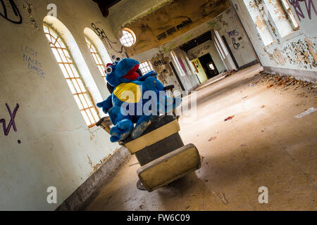 Orangeburg, New York, USA - February 17, 2016: Eerie scene with cart full of toys  inside abandoned children's ward at Rockland Stock Photo