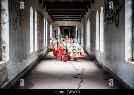 Orangeburg, New York, USA - February 17, 2016: Eerie scene with cart full of toys  inside abandoned children's ward at Rockland Stock Photo