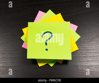 question mark on a sticky note on wooden background Stock Photo