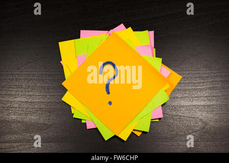 question mark on a sticky note on wooden background Stock Photo