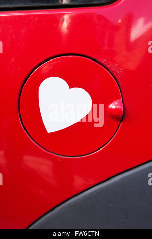 A gas cap emblazoned with a heart sticker. Stock Photo