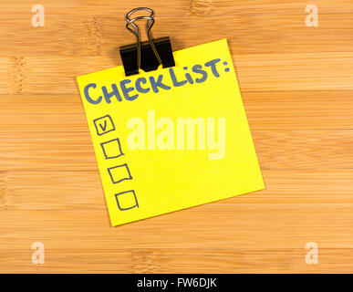 checklist sticky note on wooden background Stock Photo